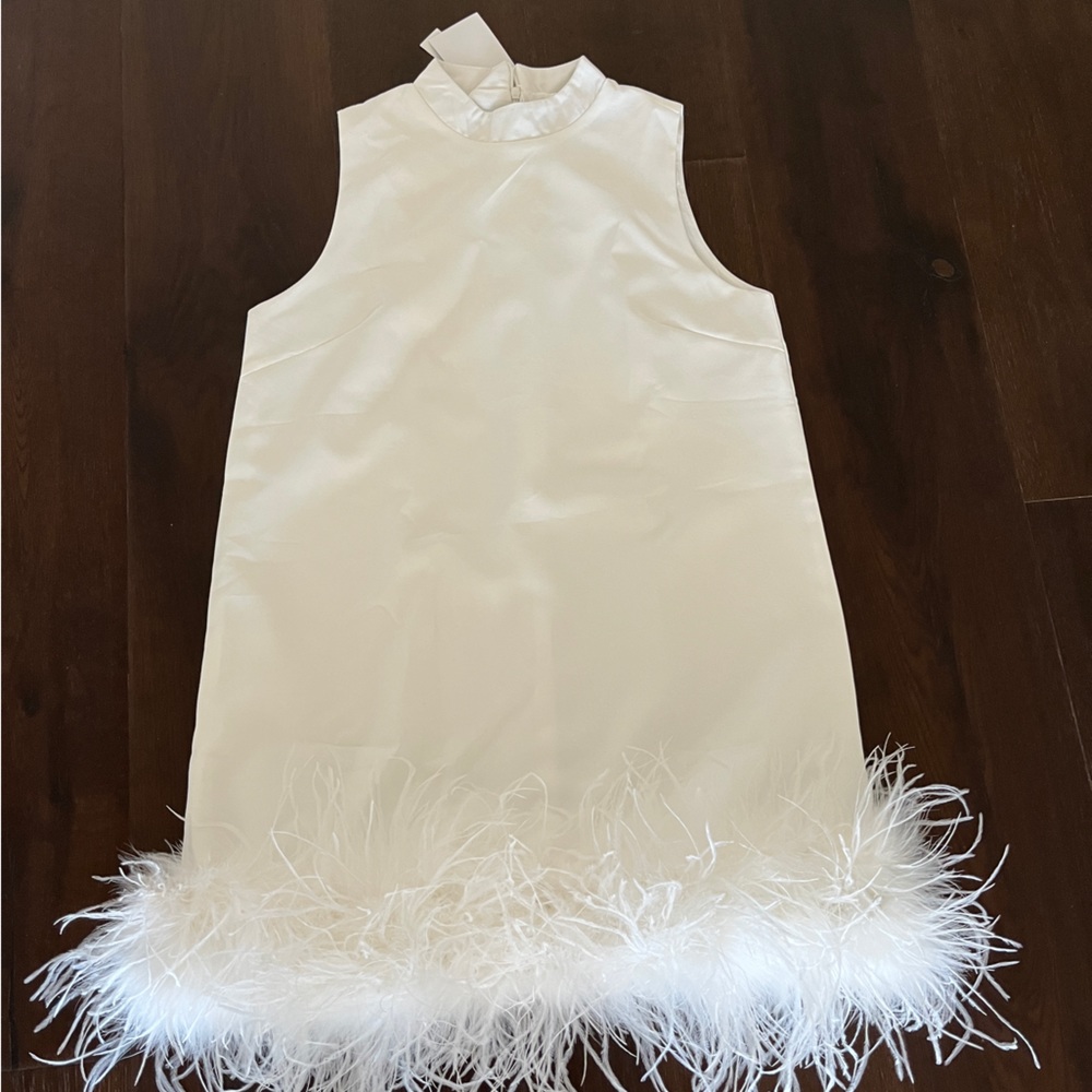 60’s style swing dress brand new with tags! With ostrich fur trim hem